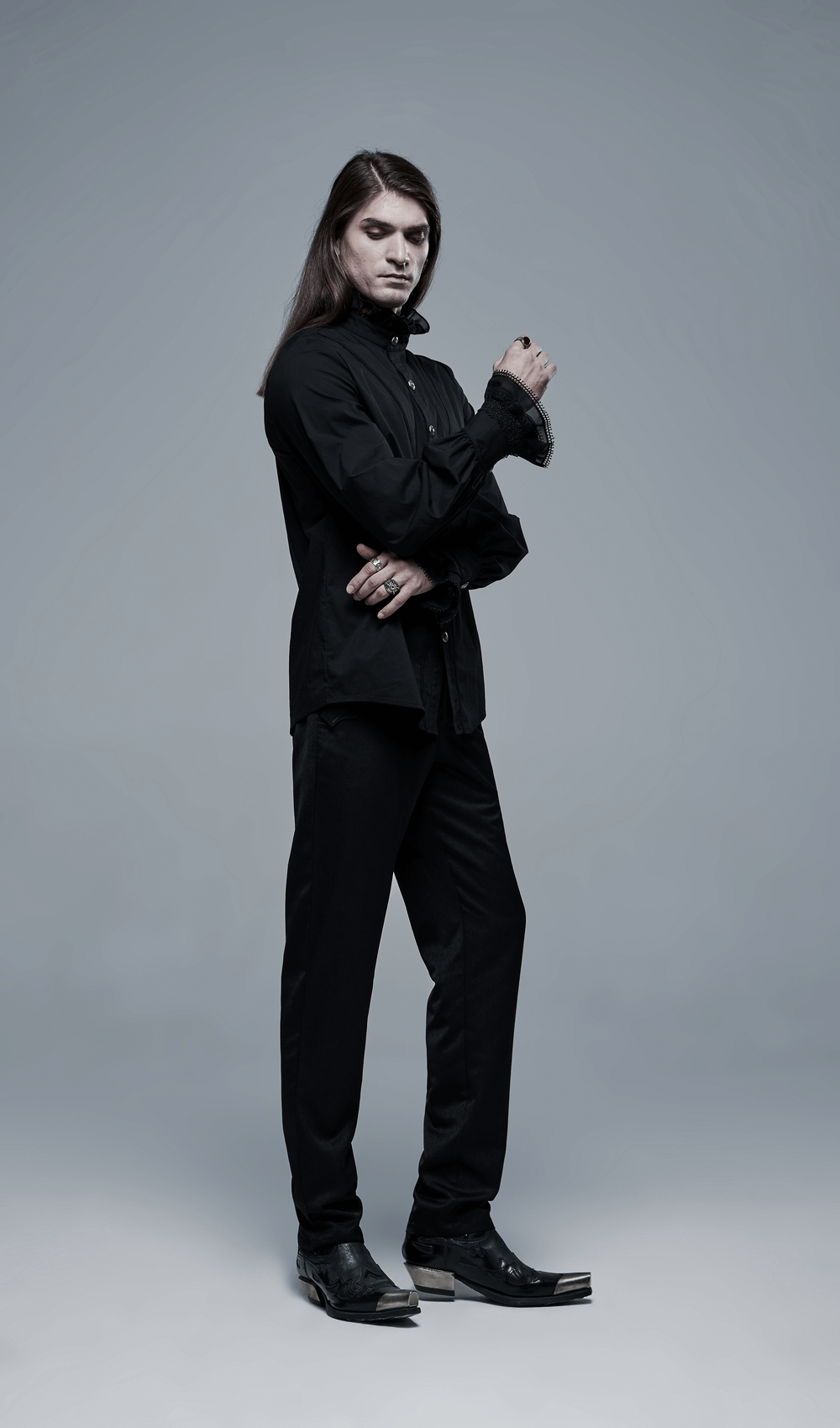 Black Gothic Victorian shirt with lace cuffs worn by a model, showcasing elegance and gothic style.