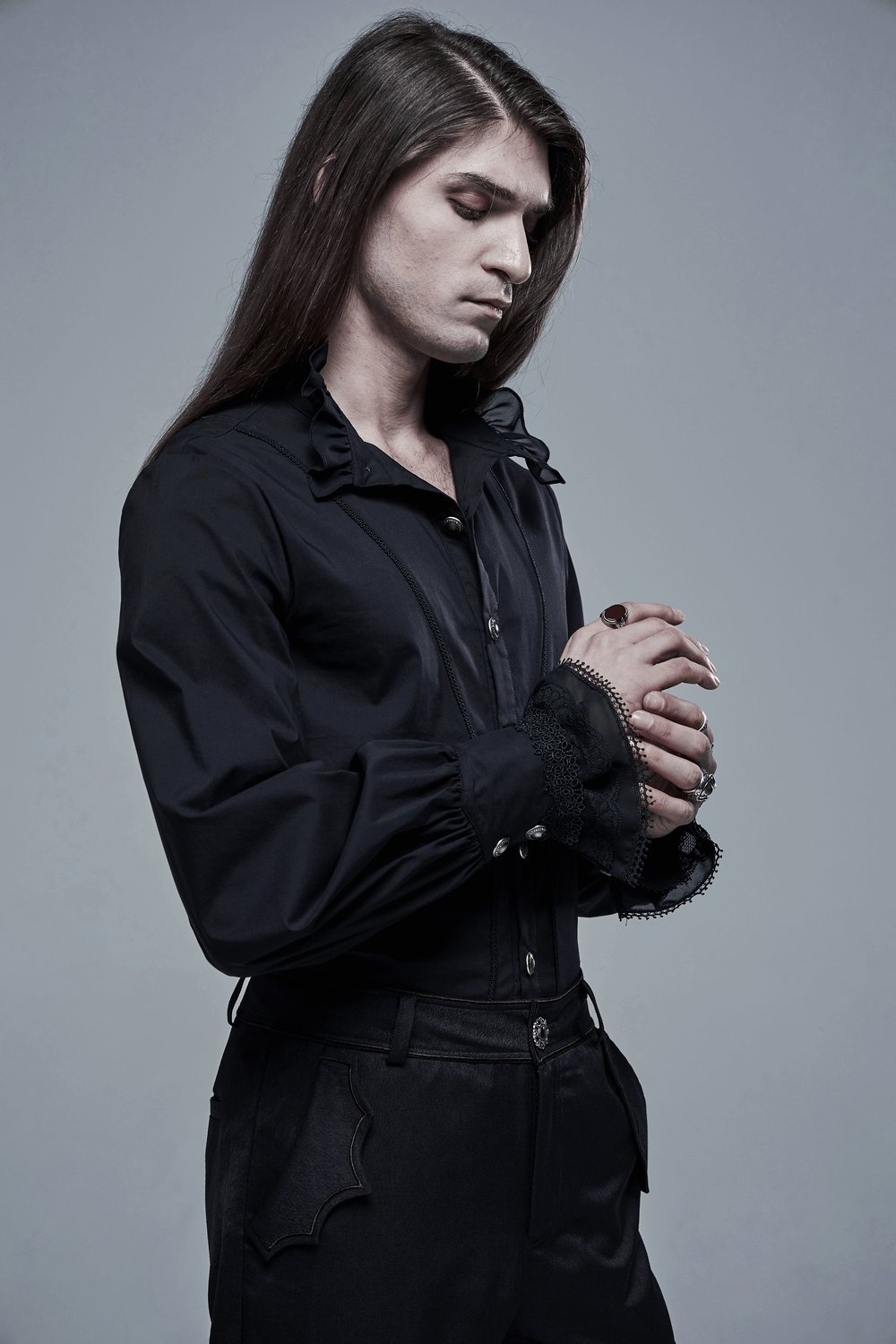 Black Gothic Victorian shirt with lace cuffs on a model, exuding elegance and gothic charm.