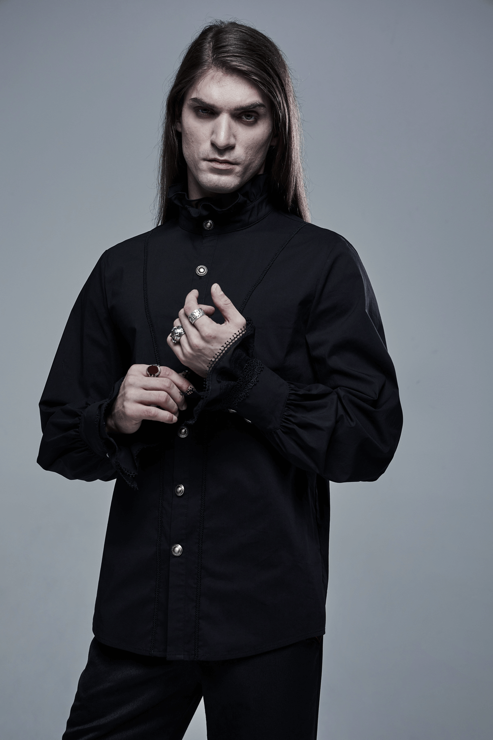 Black Gothic Victorian shirt with lace cuffs worn by a model, showcasing elegance and gothic charm.