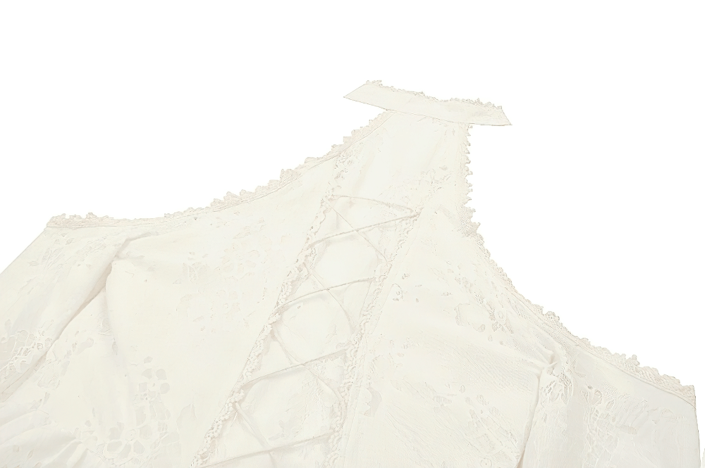 Elegant Victorian lace dress featuring open shoulder design and intricate corset lacing detail in soft beige color.