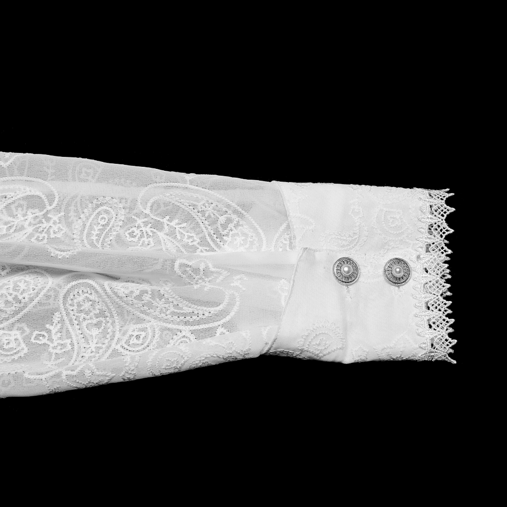 Close-up of a Victorian lace embroidered gothic shirt sleeve with elegant paisley pattern and decorative buttons.