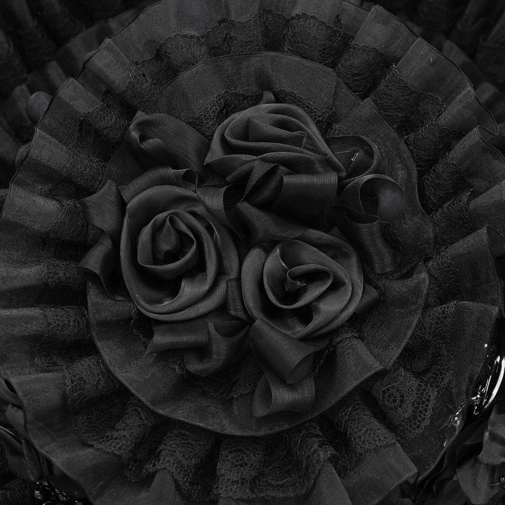 Close-up of black lace veil hat featuring ruffled trim and black roses for gothic elegance.