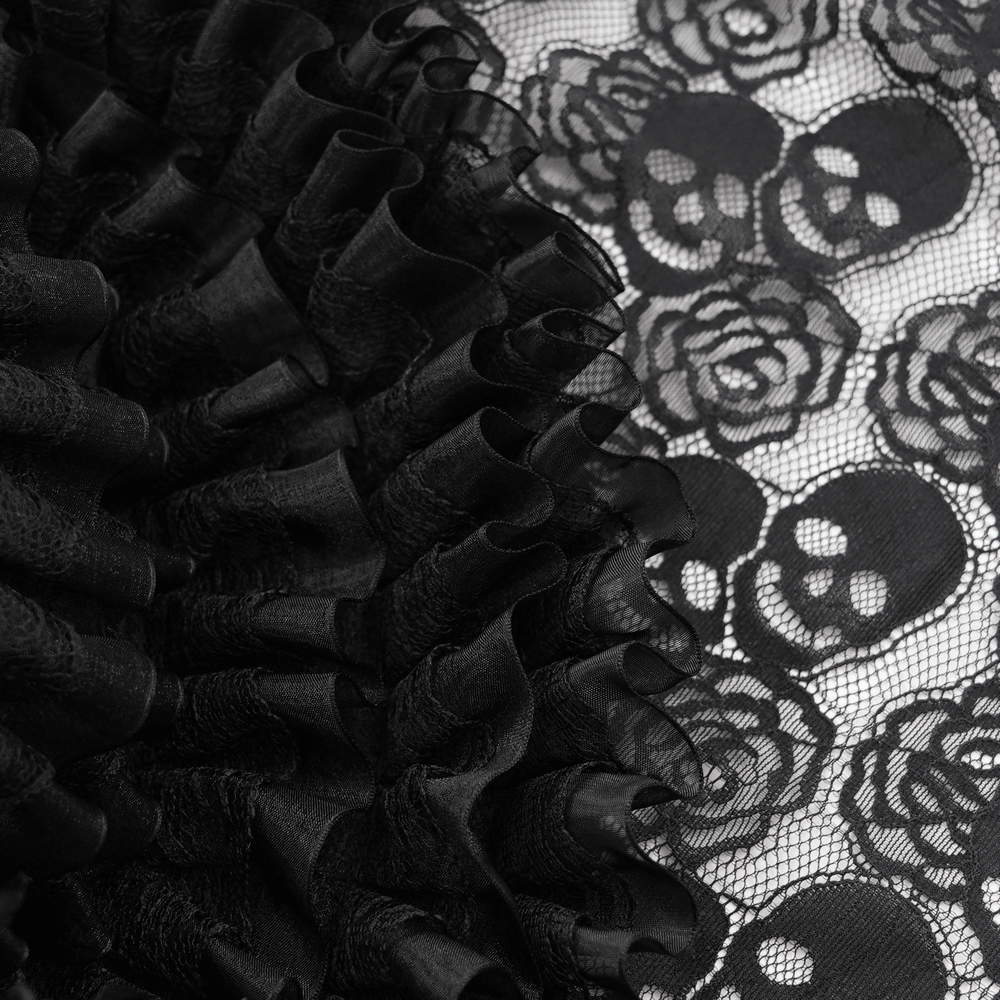 Close-up of black lace with skull and rose patterns, featuring dramatic ruffles for a gothic look.
