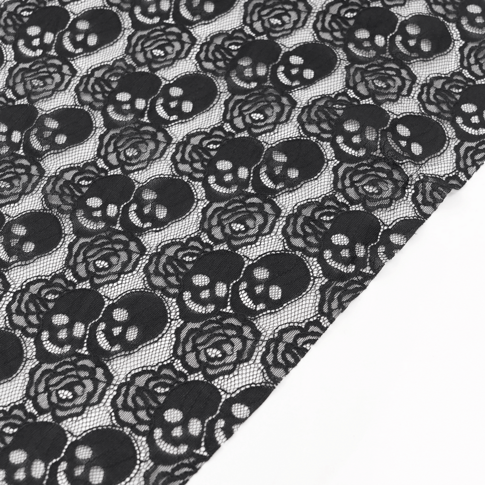 Black lace fabric featuring skull and rose patterns, ideal for gothic fashion and accessories.