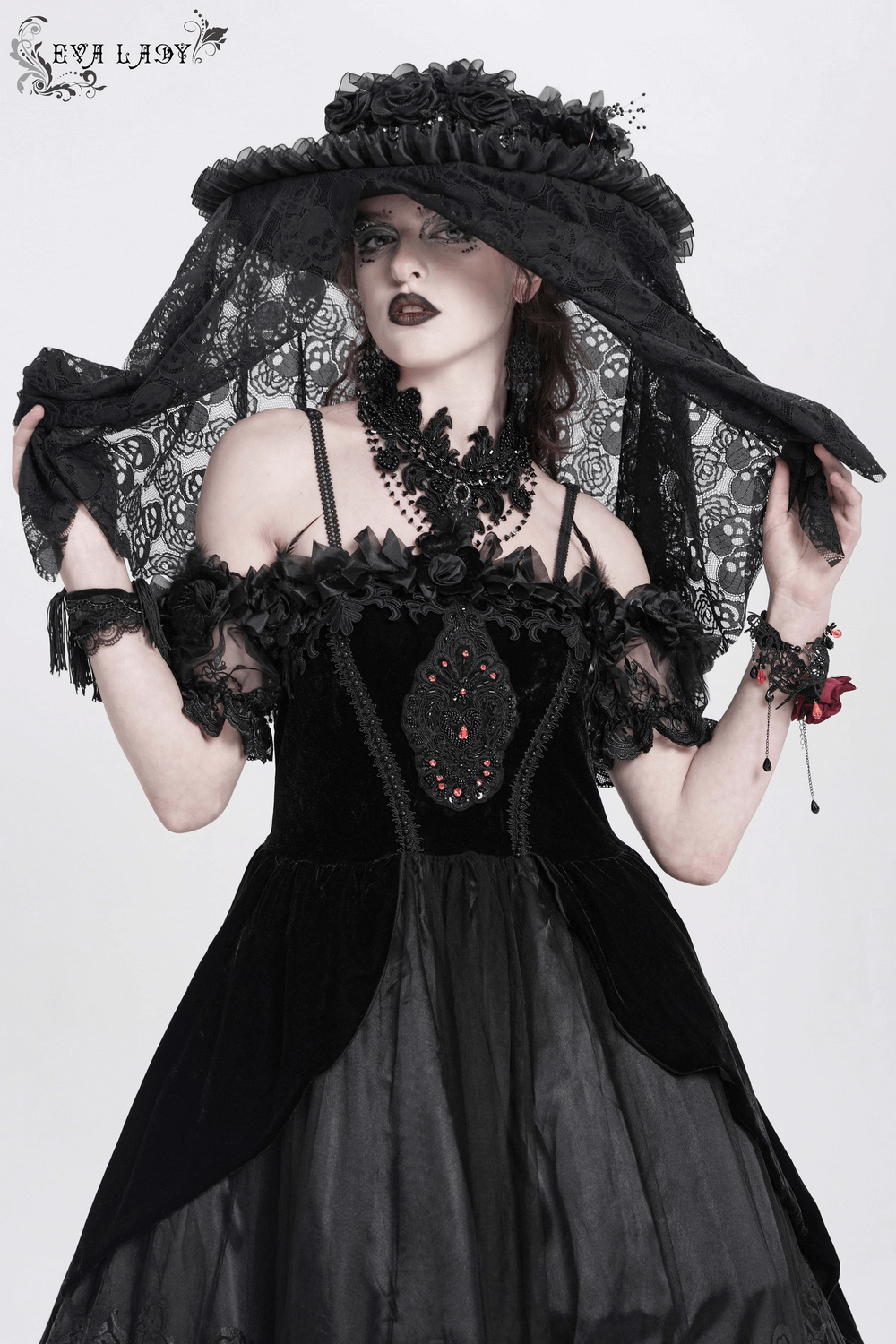 Gothic Victorian lace mourning hat with skull veil, adorned with roses and ruffle details in a dramatic dark outfit.