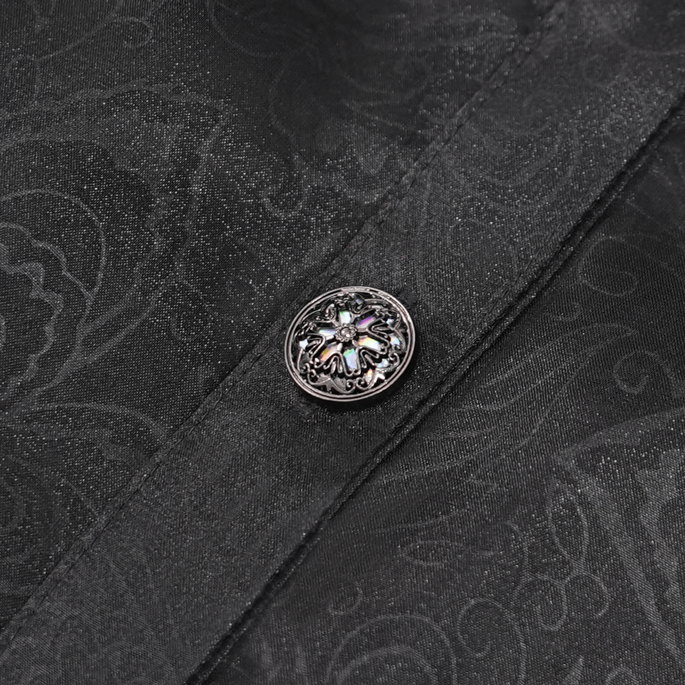 Close-up of elegant black fabric with ornate silver button detail, perfect for Victorian-inspired gothic fashion.