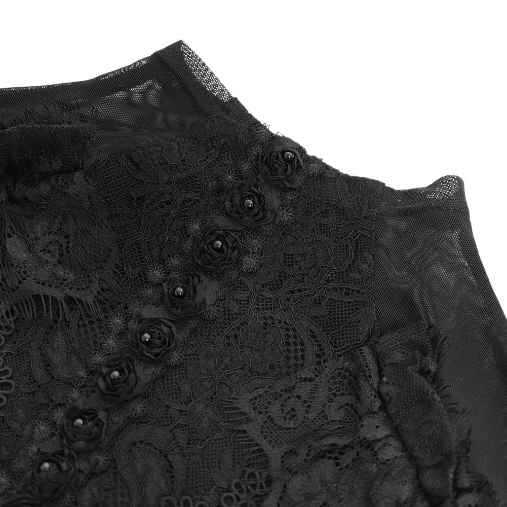 Close-up of black Victorian lace top with ruffled sleeves and floral buttons, showcasing intricate lace detail.