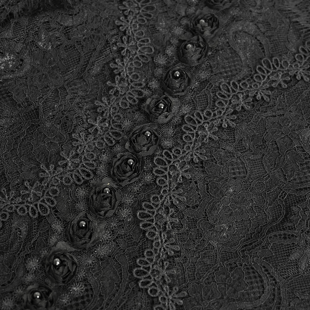 Close-up of intricate black Victorian lace featuring ruffled roses and detailed embroidery for a gothic fashion statement.