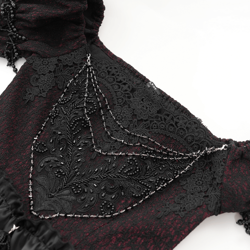Close-up of intricate black lace and beaded detail on Victorian lace-up dress in burgundy and black.