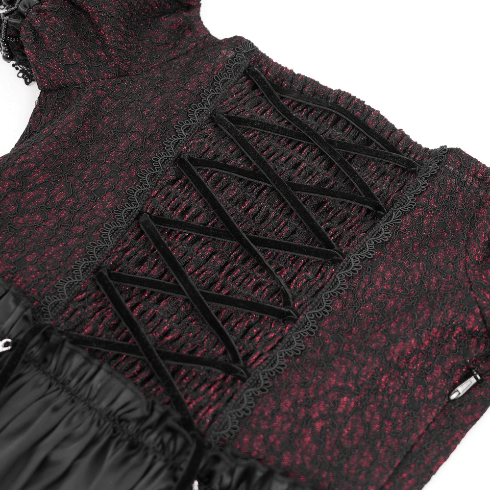 Close-up of the Victorian lace-up detailing on a black and burgundy dress with elegant ruffles.