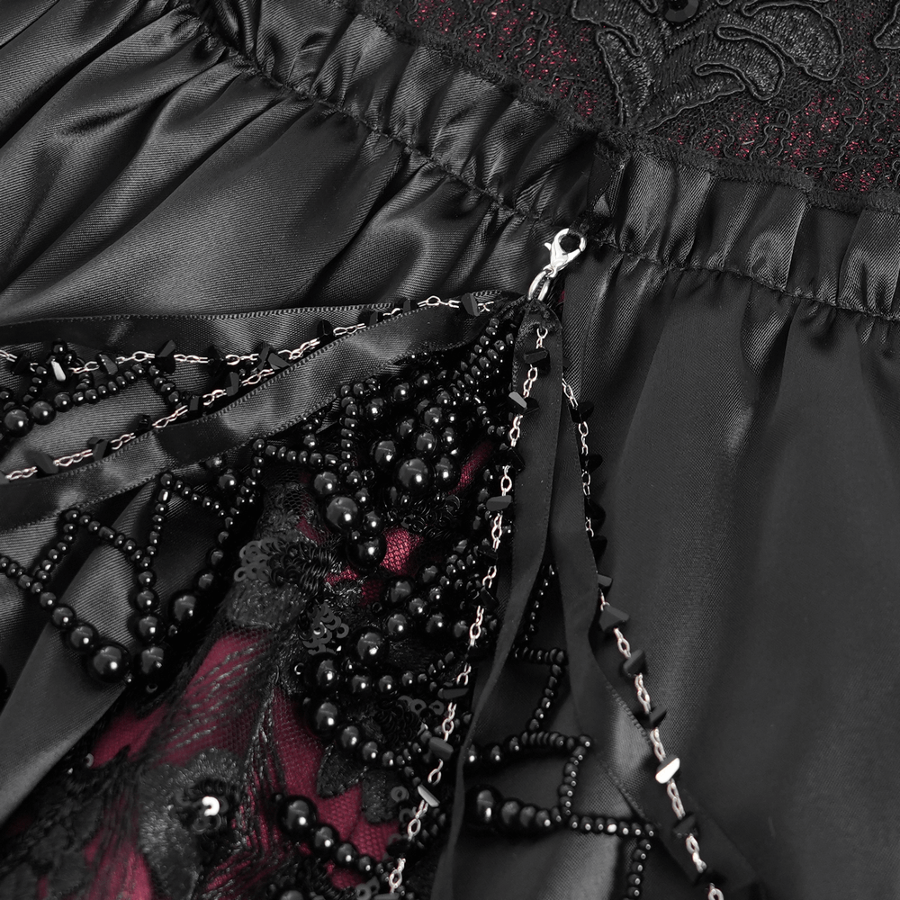 Close-up of Victorian lace-up dress showcasing intricate black beading and rich burgundy details, perfect for a gothic look.