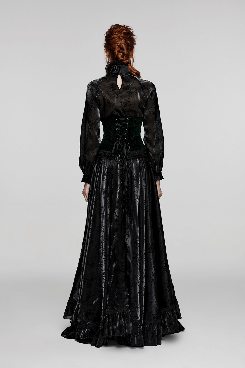 Back view of a woman in a gothic corset and flowing black gown, showcasing Victorian-inspired elegance.