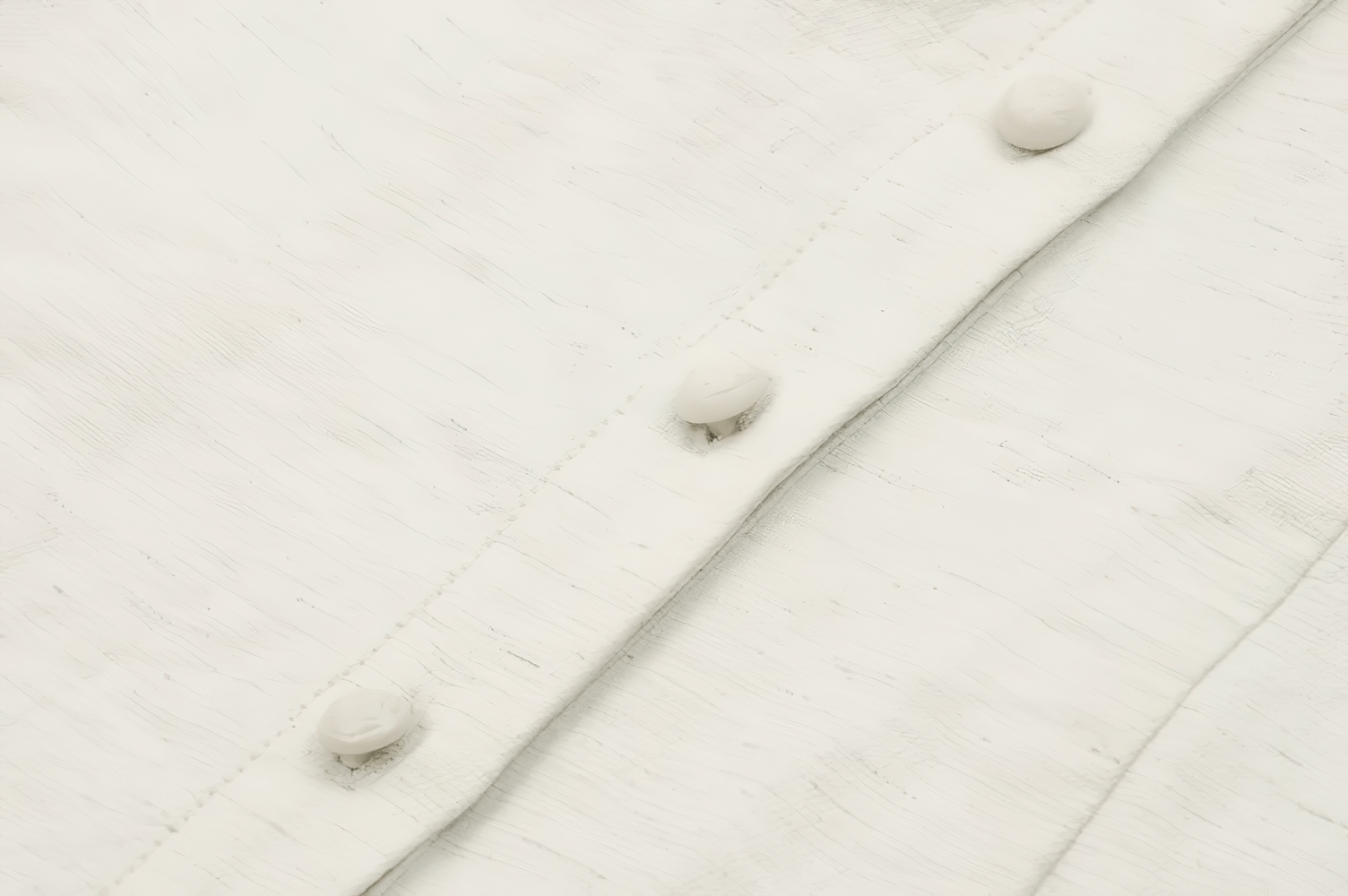 Close-up of button-down front with white buttons and textured fabric of a vintage-inspired Victorian blouse.