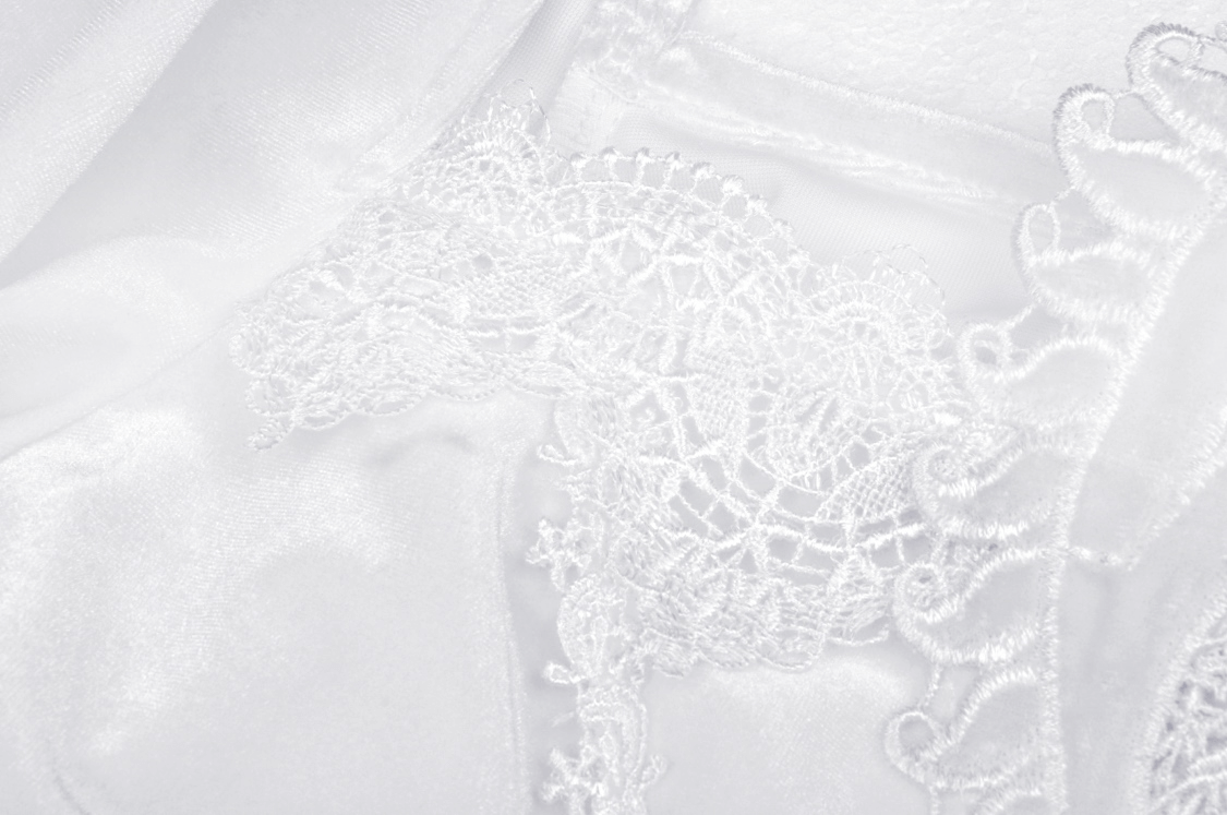 Close-up of elegant white lace detailing on a luxurious velvet dress, perfect for gothic romantic styles.