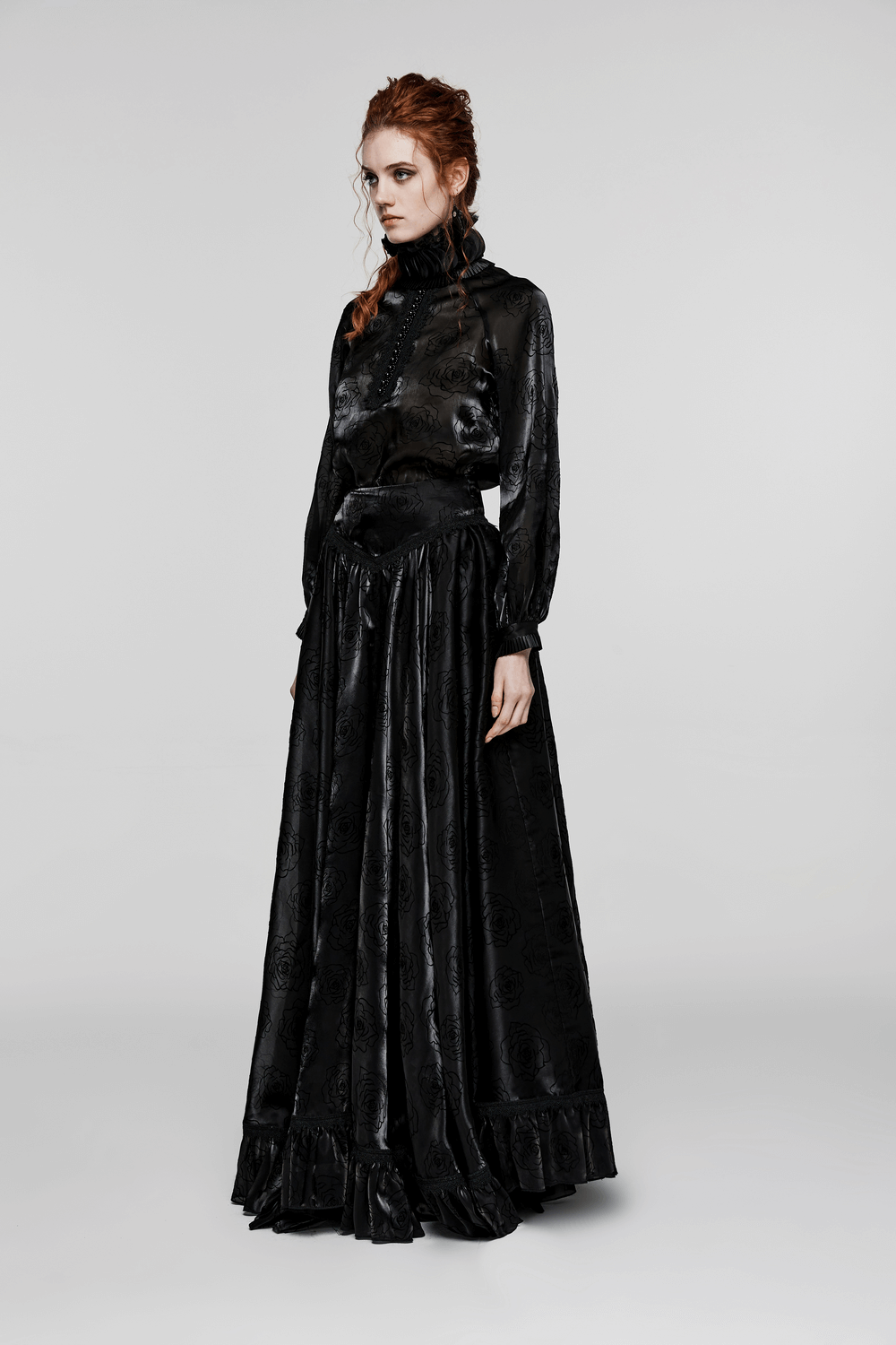 Elegant model wearing a black Victorian-inspired gothic ruffle shirt and long skirt, showcasing dark romantic fashion.