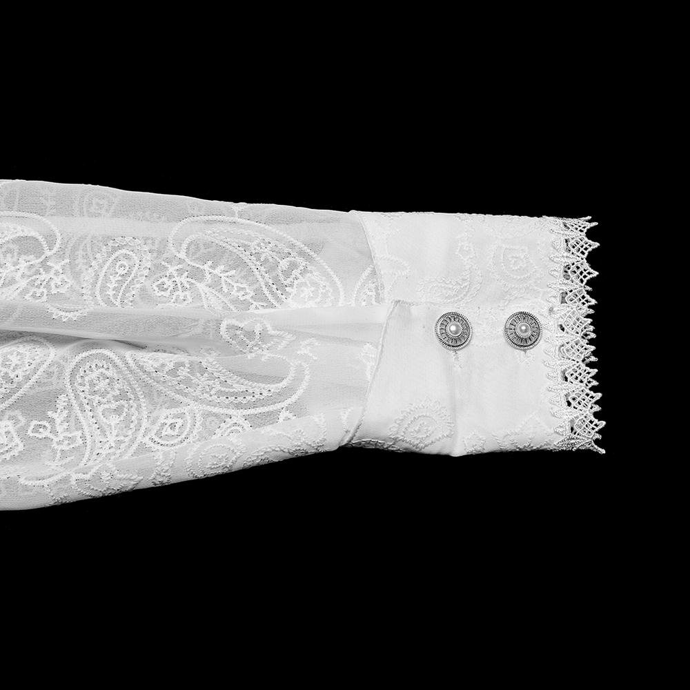 Elegant Victorian ruffle shirt cuff featuring lace detail and gemstone buttons on a black background.