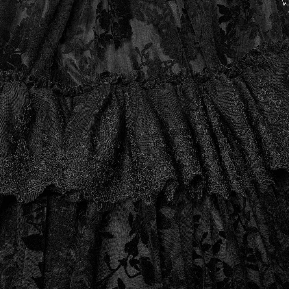 Close-up of black Victorian lace flocking detail on a Gothic layered dress, showcasing ruffles and intricate patterns.