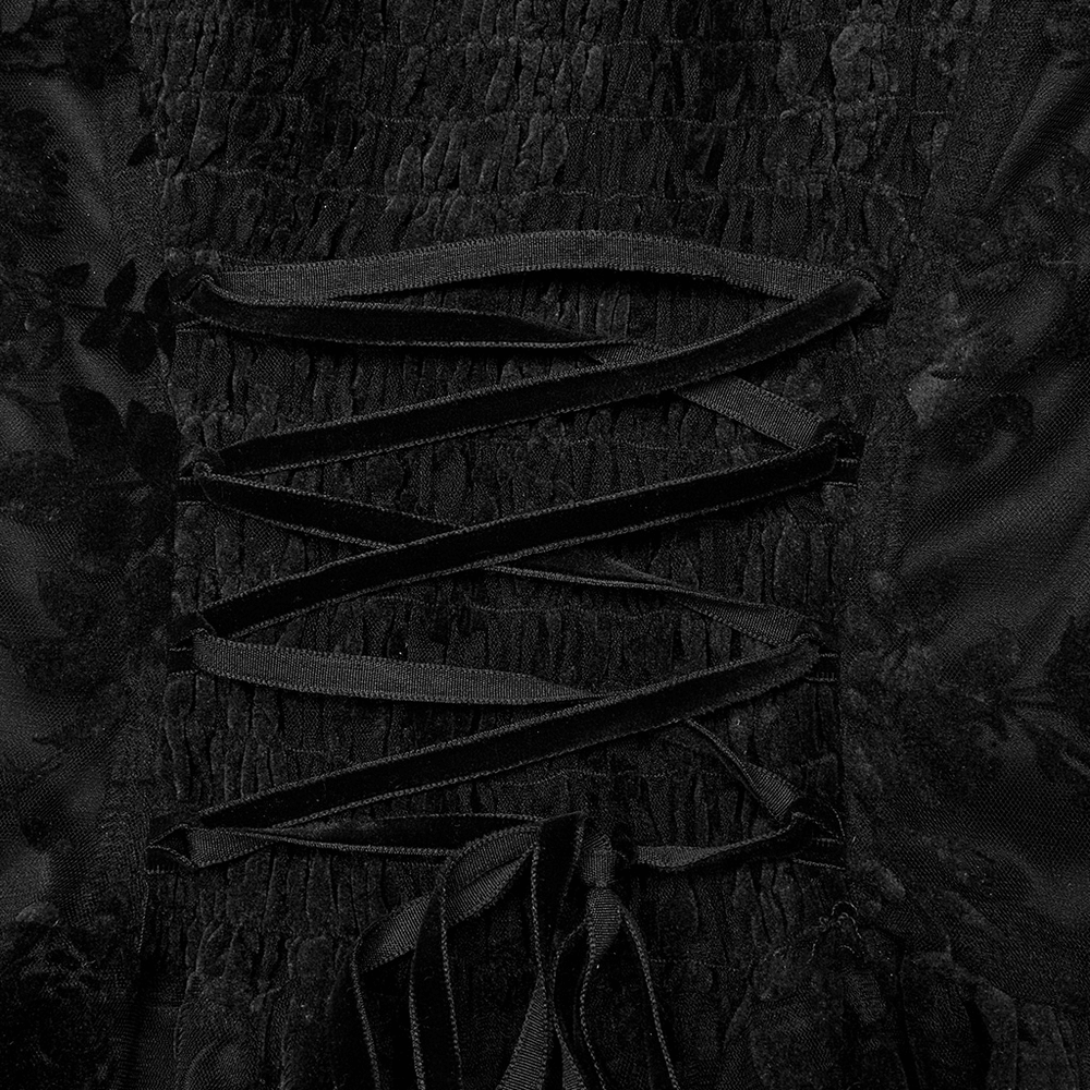 Close-up of layered black flocking lace detailing and corset-style lacing on a Victorian Goth dress.