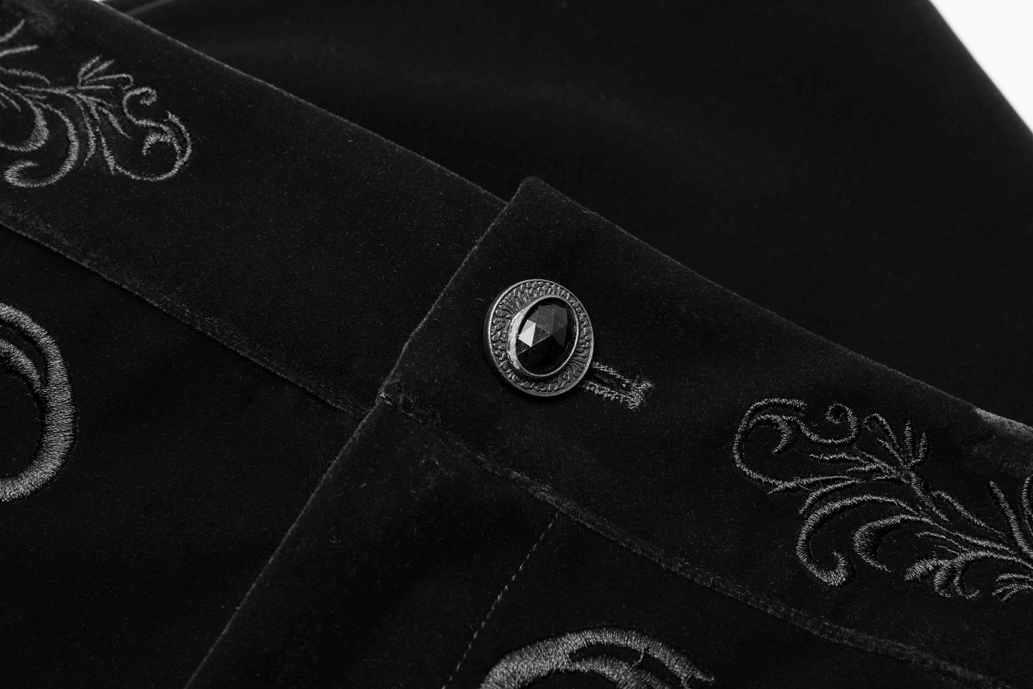 Close-up of intricate Gothic embroidery and button detail on Victorian Style Black Velvet Trousers.
