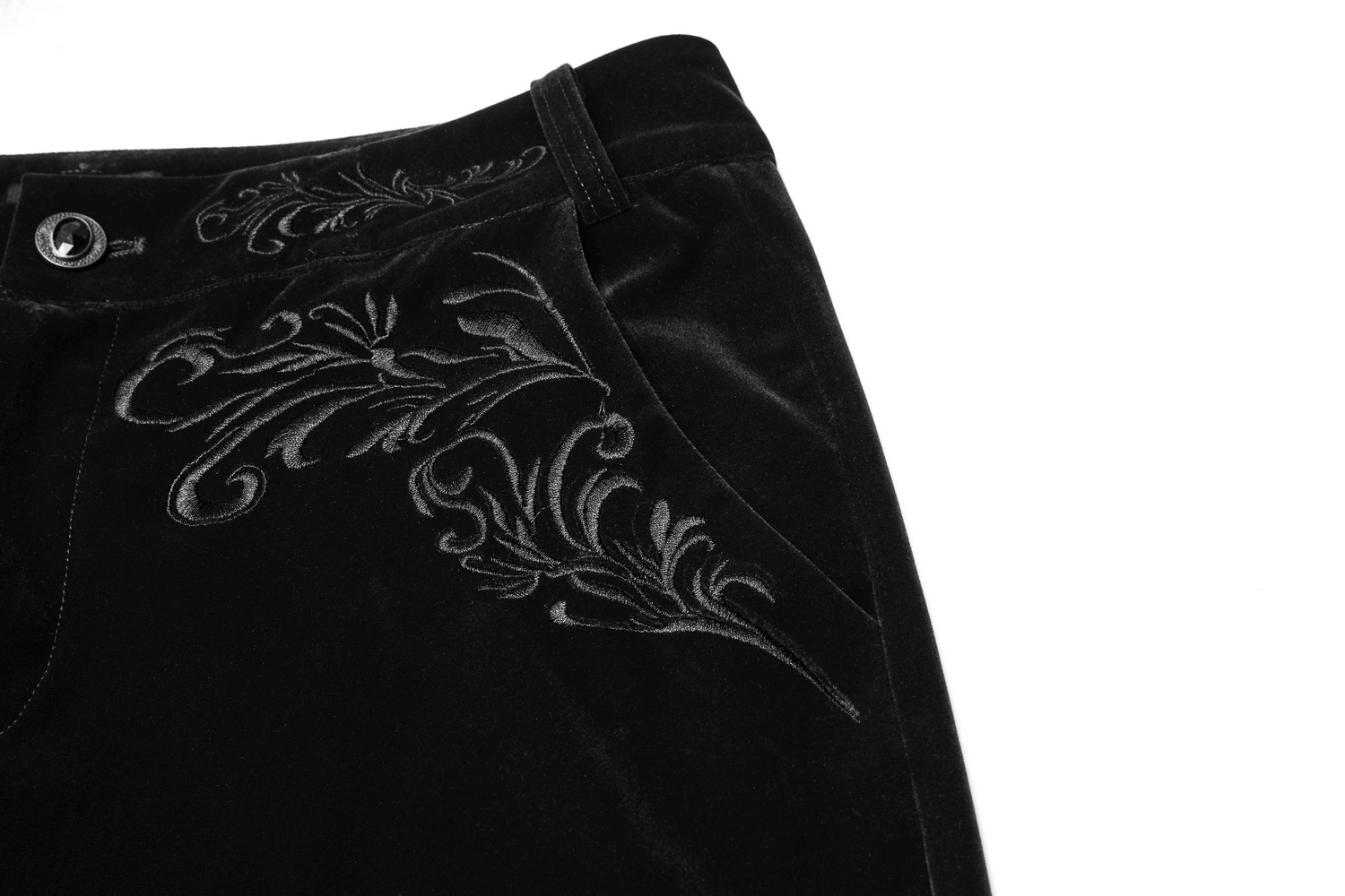 Close-up of Victorian style black velvet trousers featuring intricate Gothic embroidery on the front.