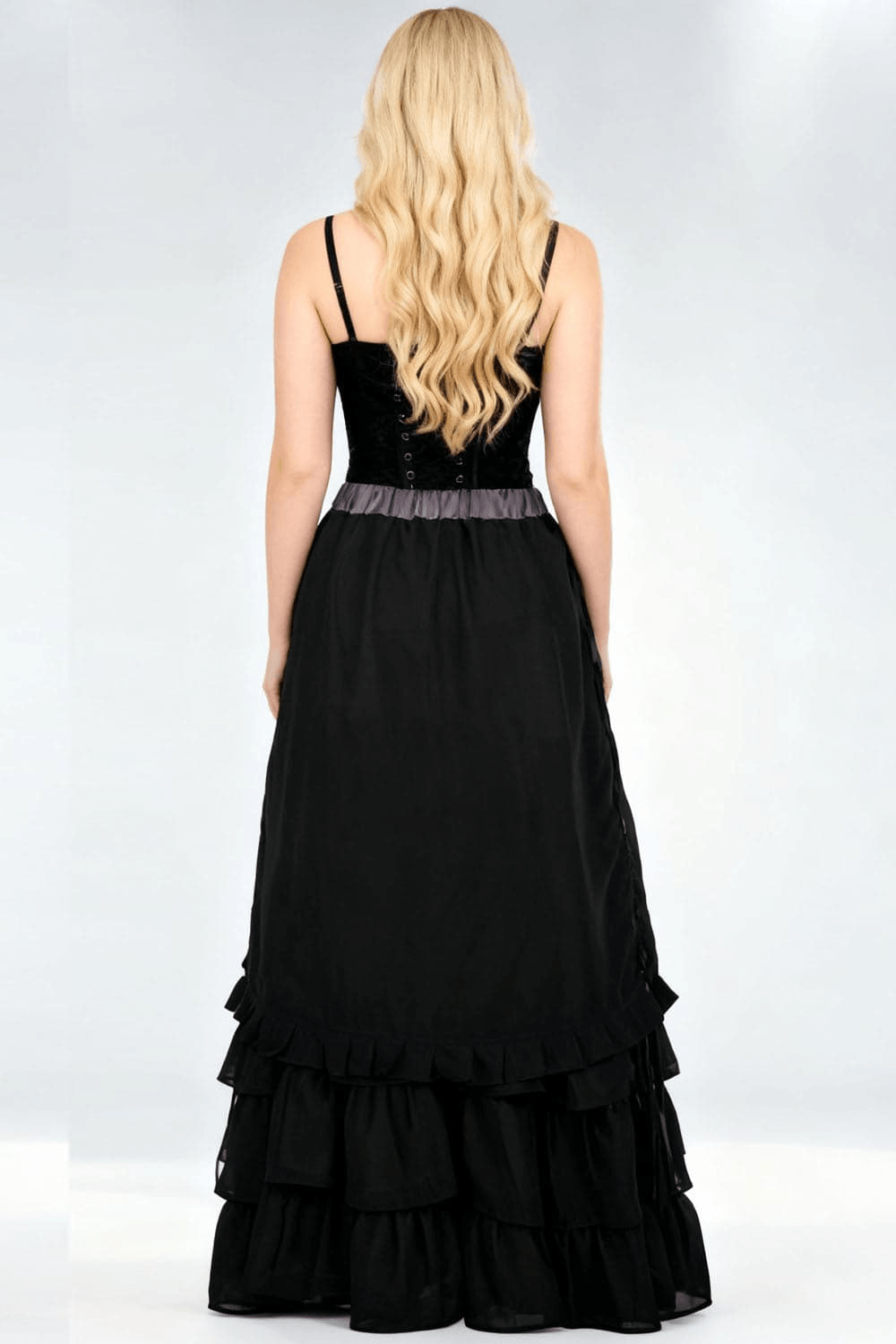 Back view of a woman wearing a Victorian Tiered Maxi Skirt with Ruffle Hem and Waistband in black.