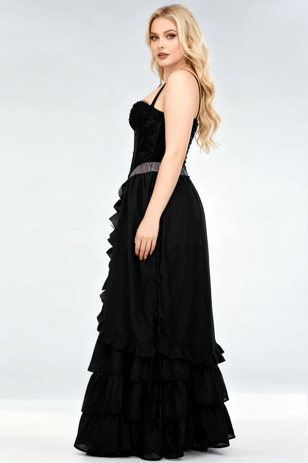 Victorian Tiered Maxi Skirt with Ruffle Hem and Waistband shown on model from side angle, highlighting flowing ruffles.