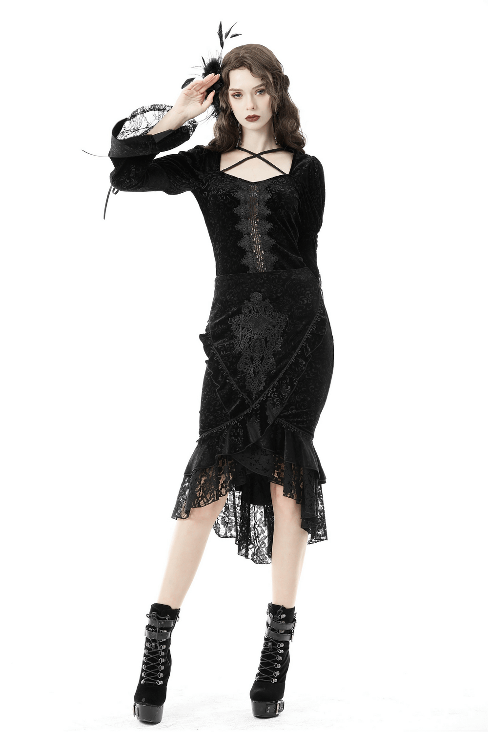 Elegant woman in a black Victorian velvet fishtail skirt with lace overlay, showcasing a dramatic high-low hem.