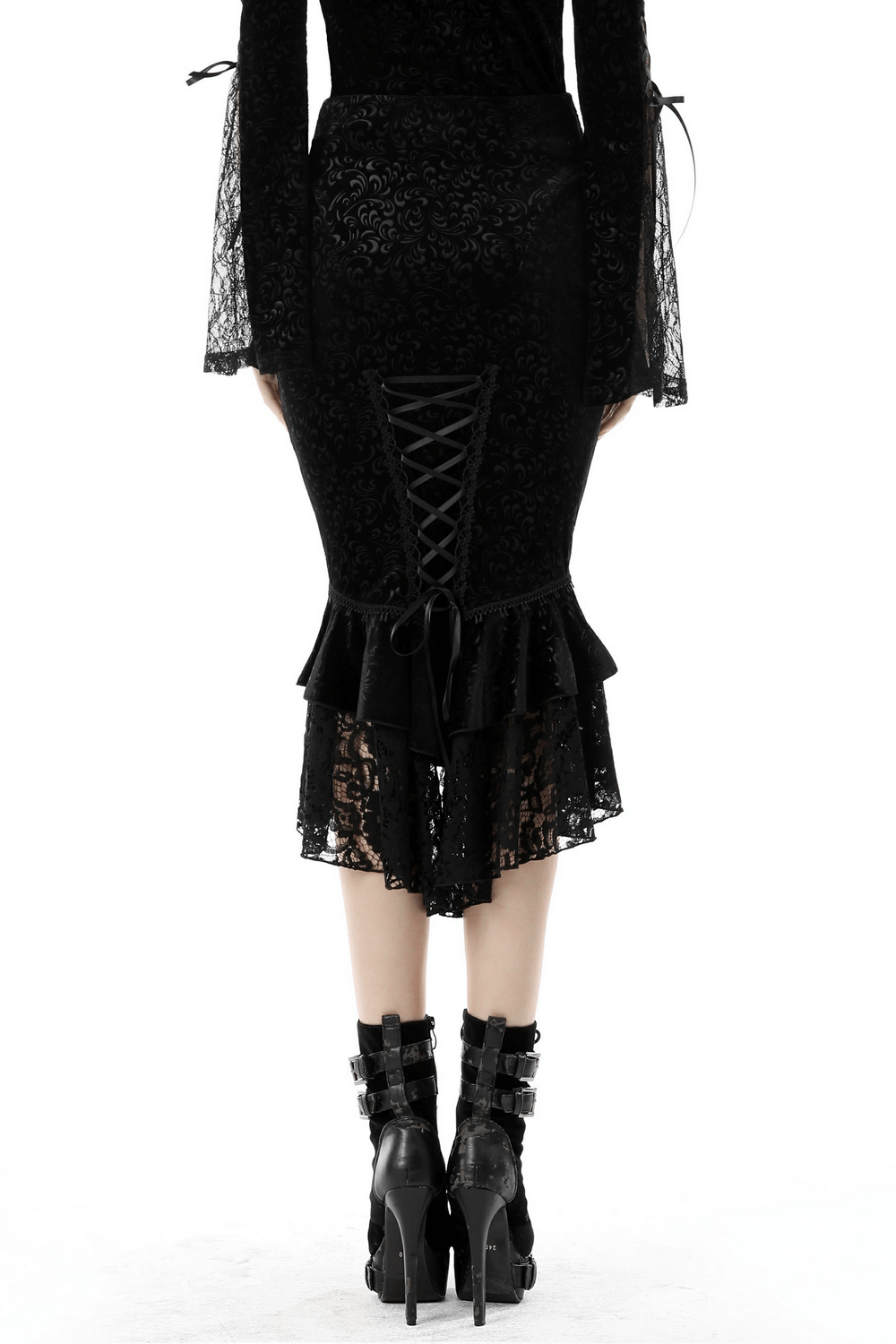 Back view of a black velvet fishtail skirt with lace overlay and dramatic hem, showcasing Gothic elegance.