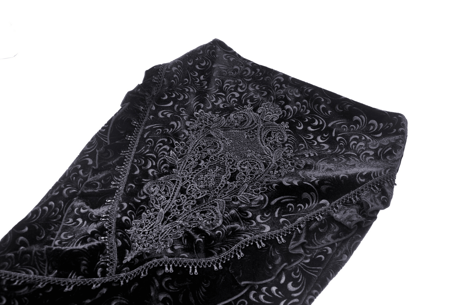 Close-up of intricate baroque pattern on black velvet fishtail skirt with lace trim, showcasing gothic Victorian style.