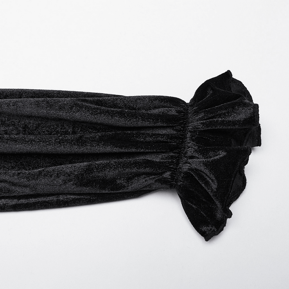 Close-up of a black velvet sleeve featuring a ruffle-flared design, embodying Victorian Gothic elegance.