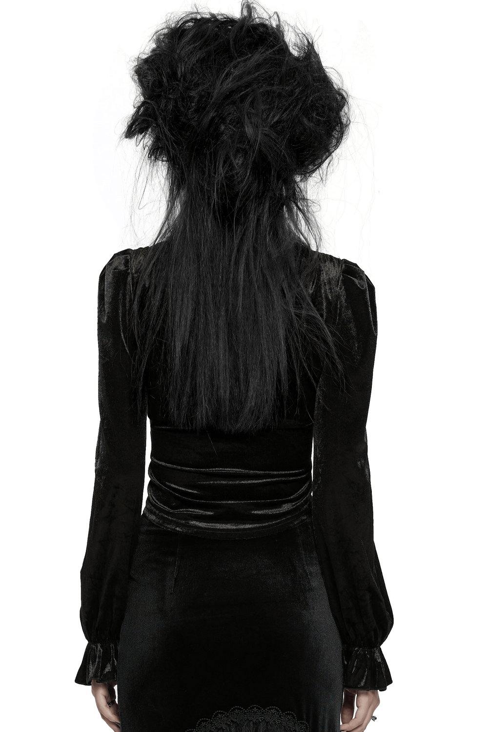Back view of a woman in a Victorian velvet Gothic blouse with ruffle sleeves and voluminous hair, showcasing retro elegance.