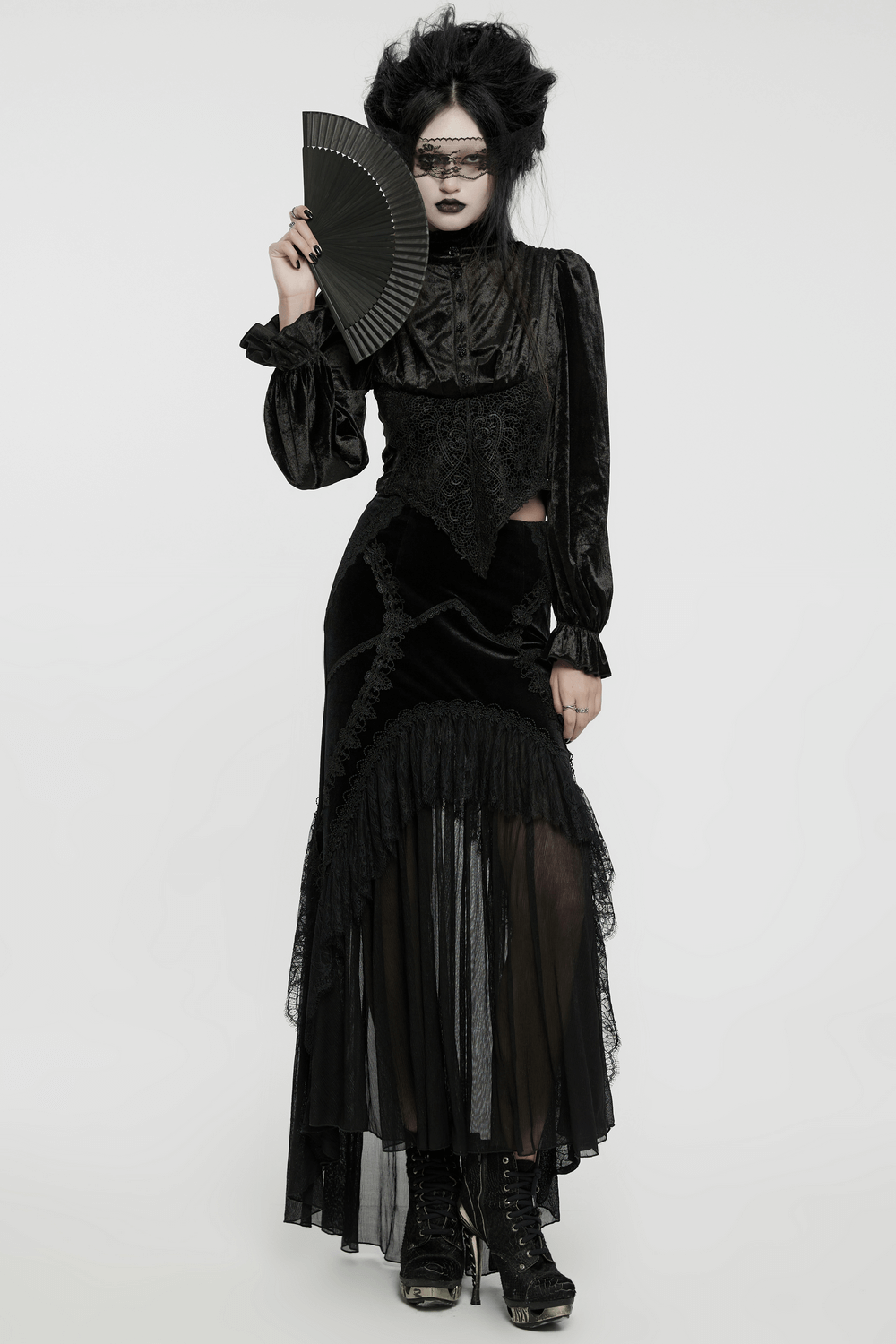 Elegant Victorian Gothic blouse and skirt in black velvet with intricate lace, styled with a fan and dramatic makeup.