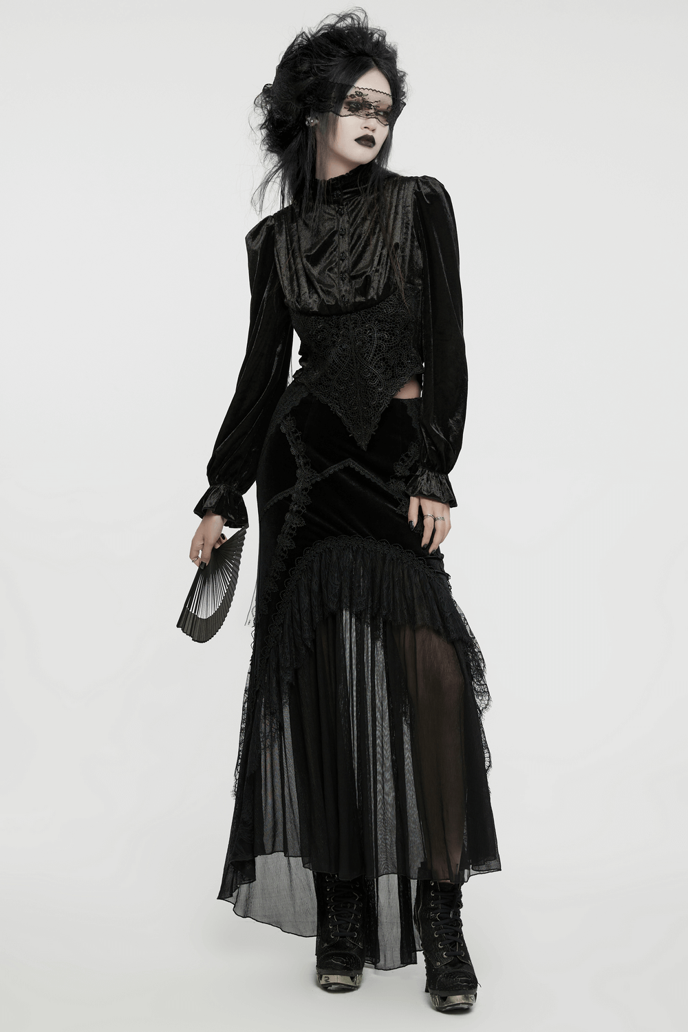 Gothic Victorian-style blouse with lace accents, paired with a flowing black skirt and dramatic accessories.