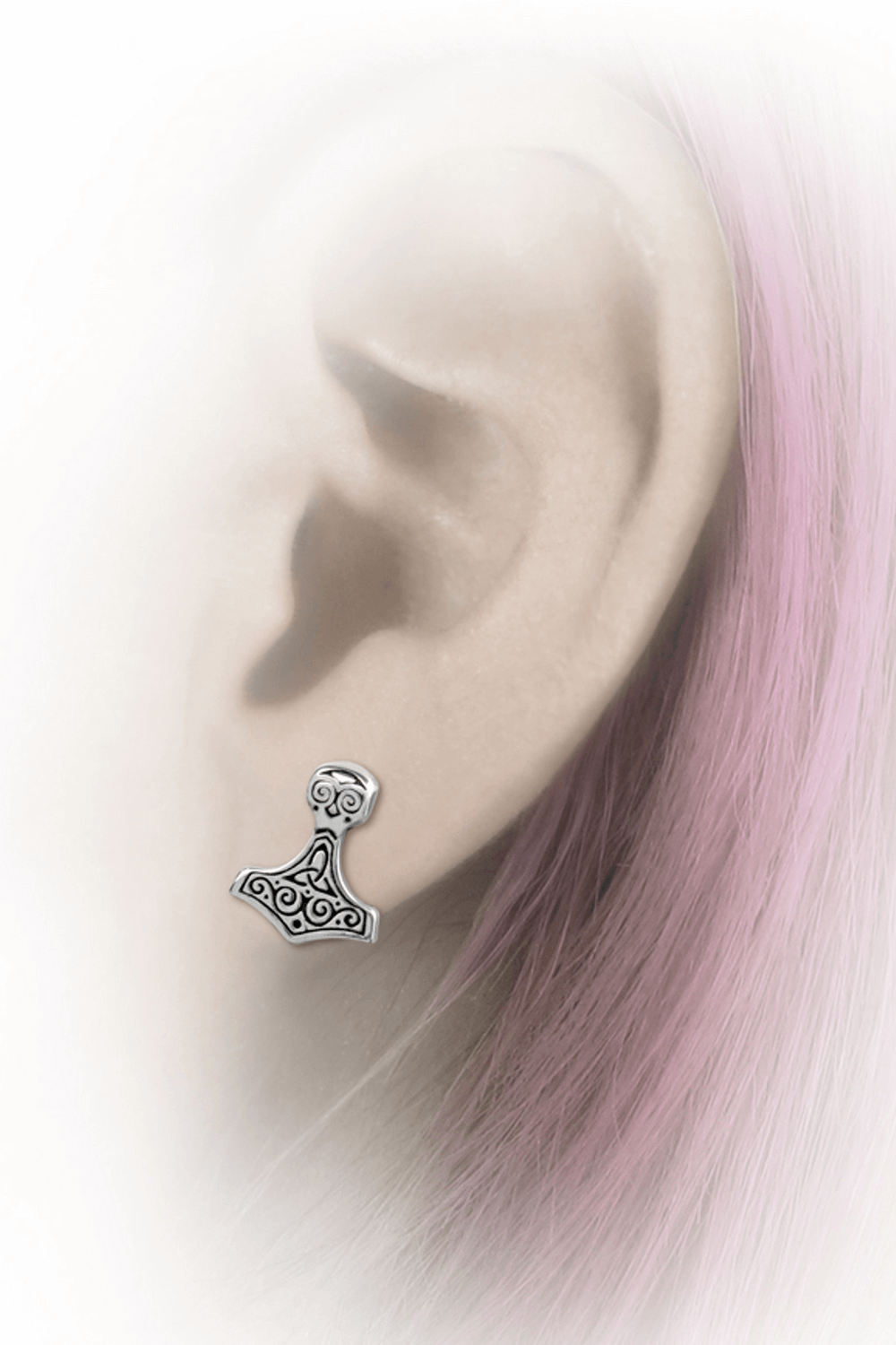 Celtic Thor's hammer ear studs worn, showcasing intricate Norse design and craftsmanship.