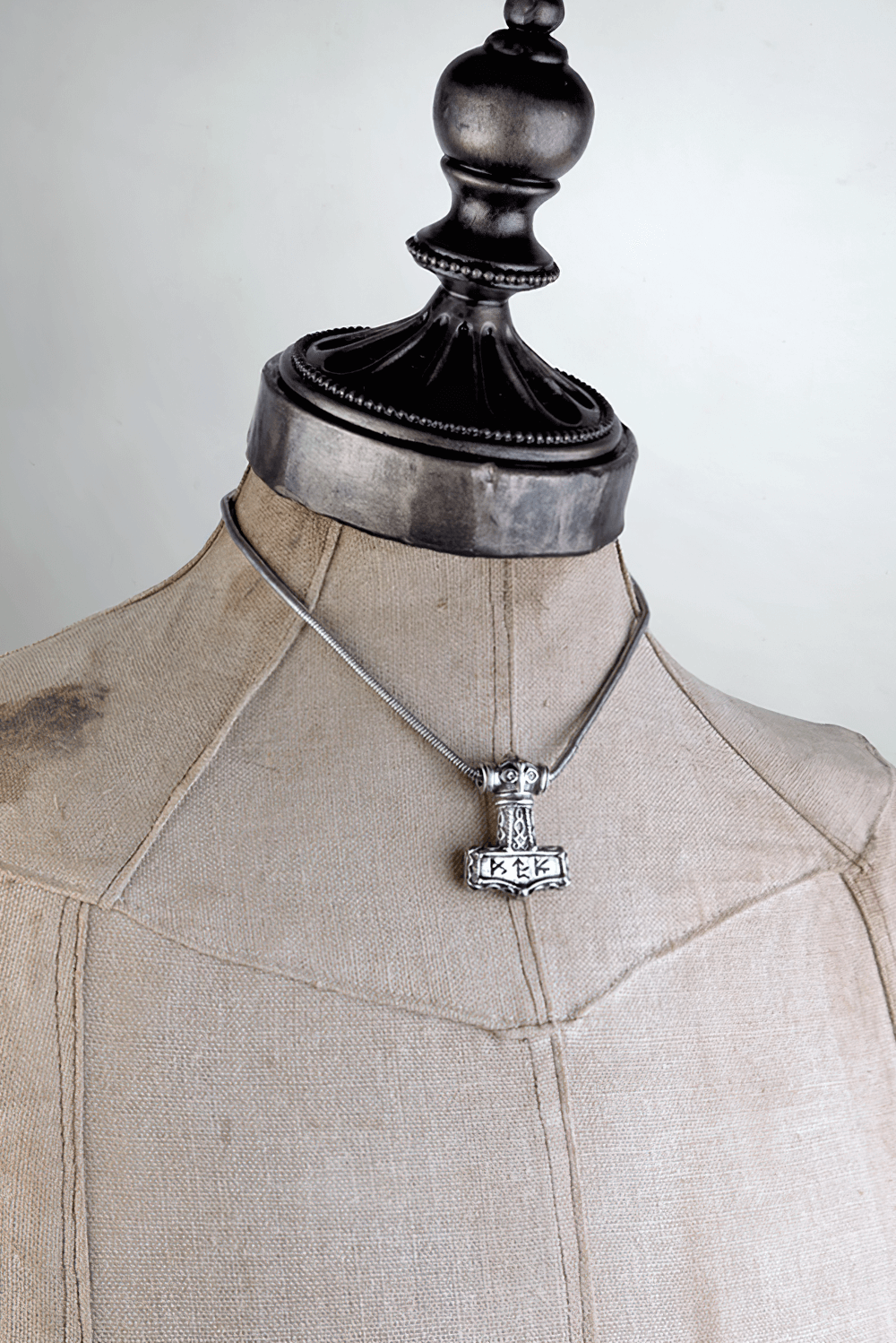 Viking Thor's Hammer pendant with bindrune design displayed on a mannequin, showcasing Norse heritage and craftsmanship.