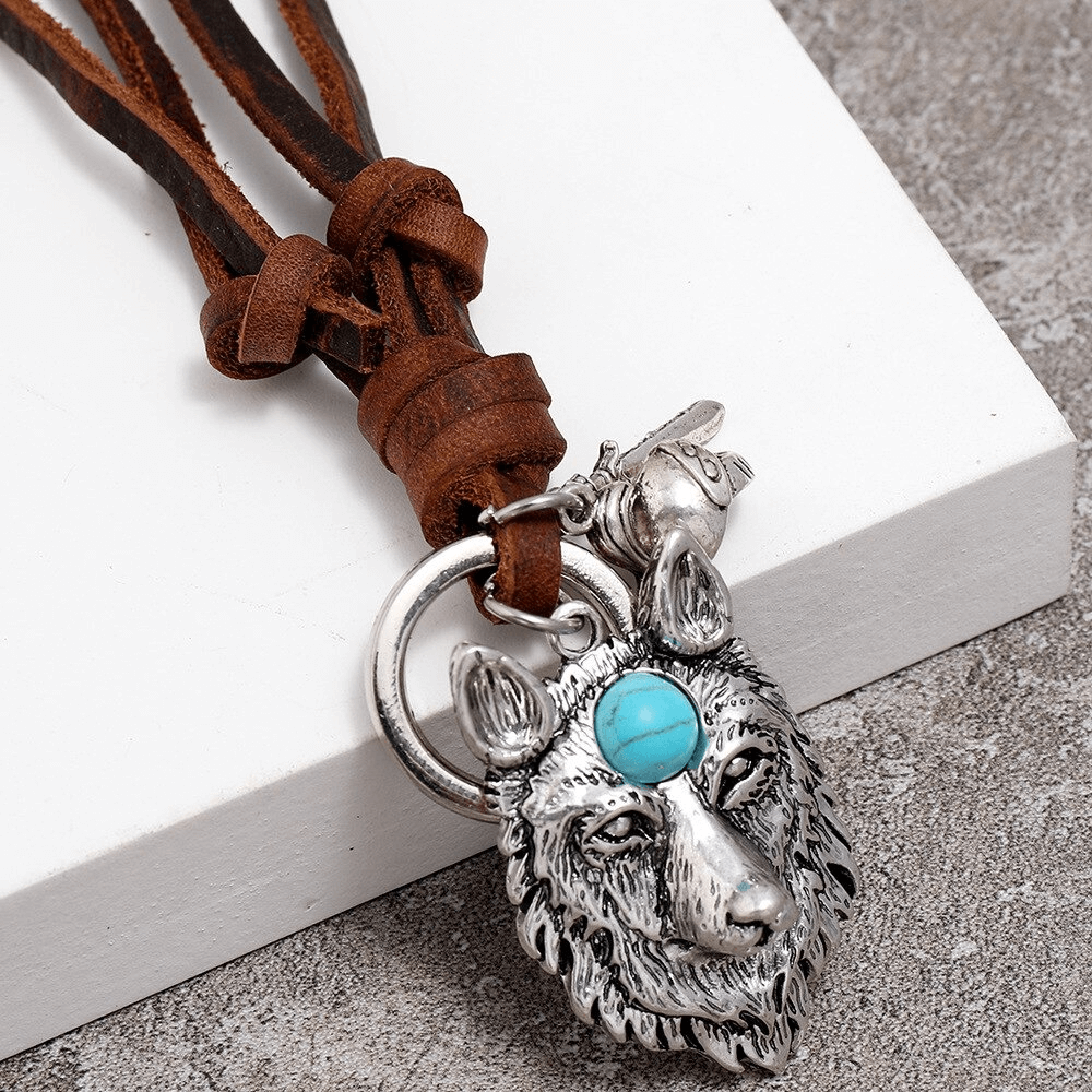Vintage brown leather necklace with detailed silver wolf head pendant and turquoise stone centerpiece.