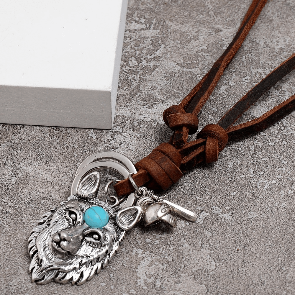 Vintage brown leather necklace featuring a detailed silver wolf head pendant with turquoise accent.
