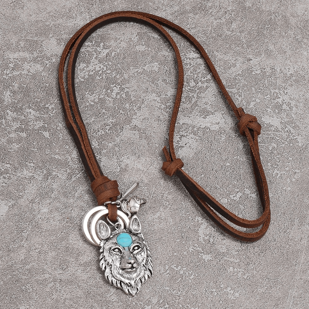 Vintage brown leather necklace with silver wolf head pendant and turquoise accent, perfect for punk fashion lovers.