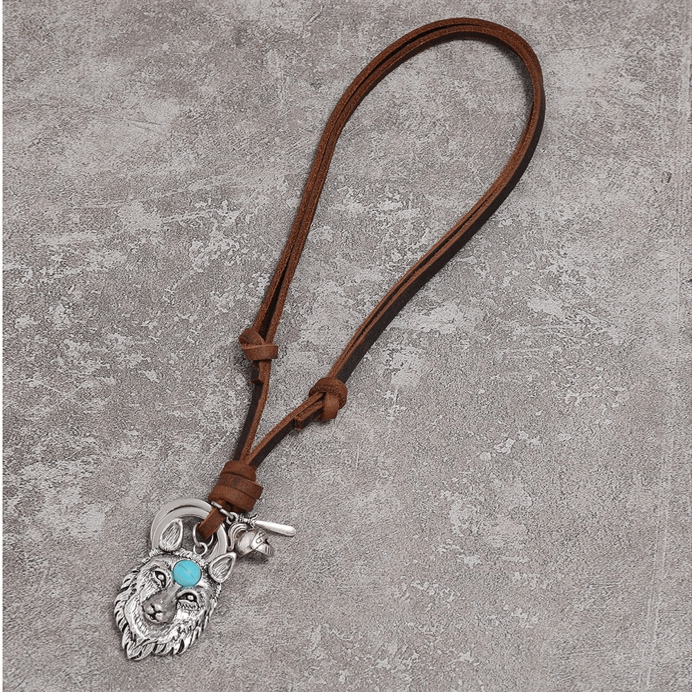 Vintage brown leather necklace with a detailed wolf head pendant and turquoise accent.