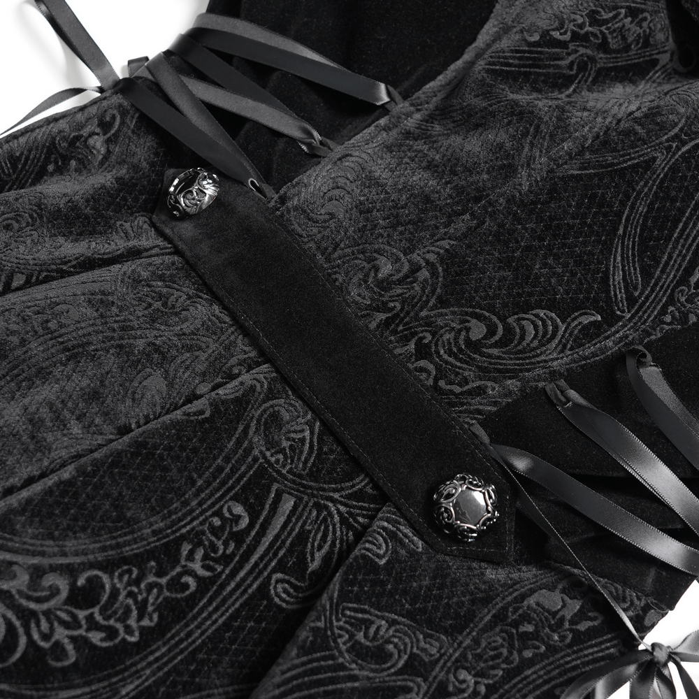 Close-up of vintage black velvet coat with intricate lace, black buttons, and satin ribbons.