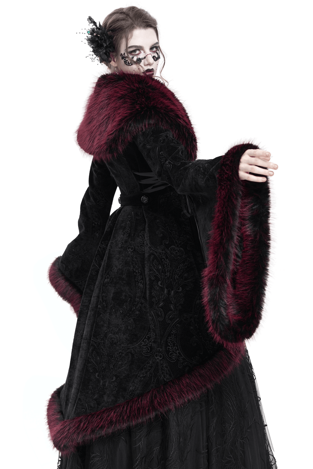 Woman in vintage black coat with burgundy faux fur trim, showcasing gothic elegance and intricate lace details.