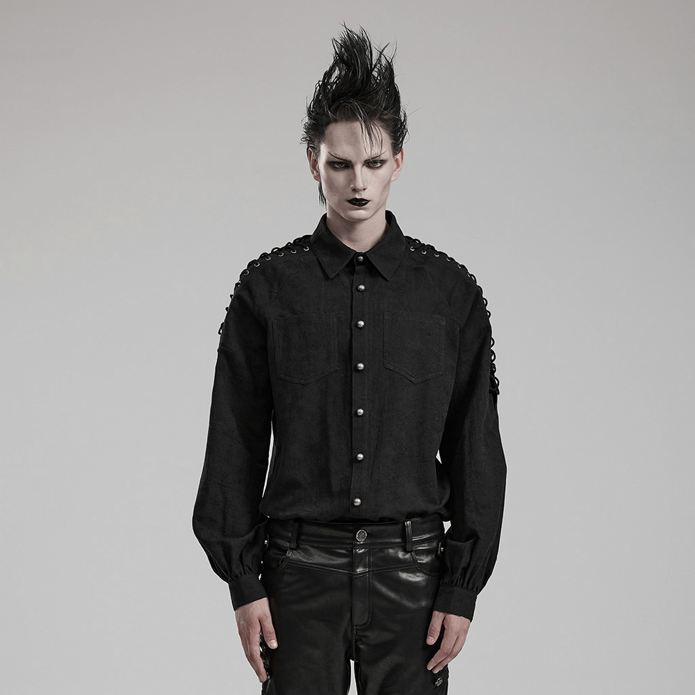 Man in vintage black lace-up gothic shirt with stylish lace detail and hand-sewn buttons, showcasing gothic fashion.
