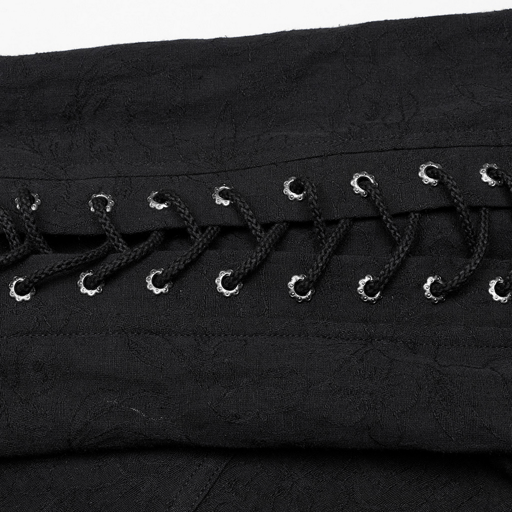 Close-up of vintage black lace-up detailing on Gothic shirt for men, showcasing intricate eyelet and woven fabric.