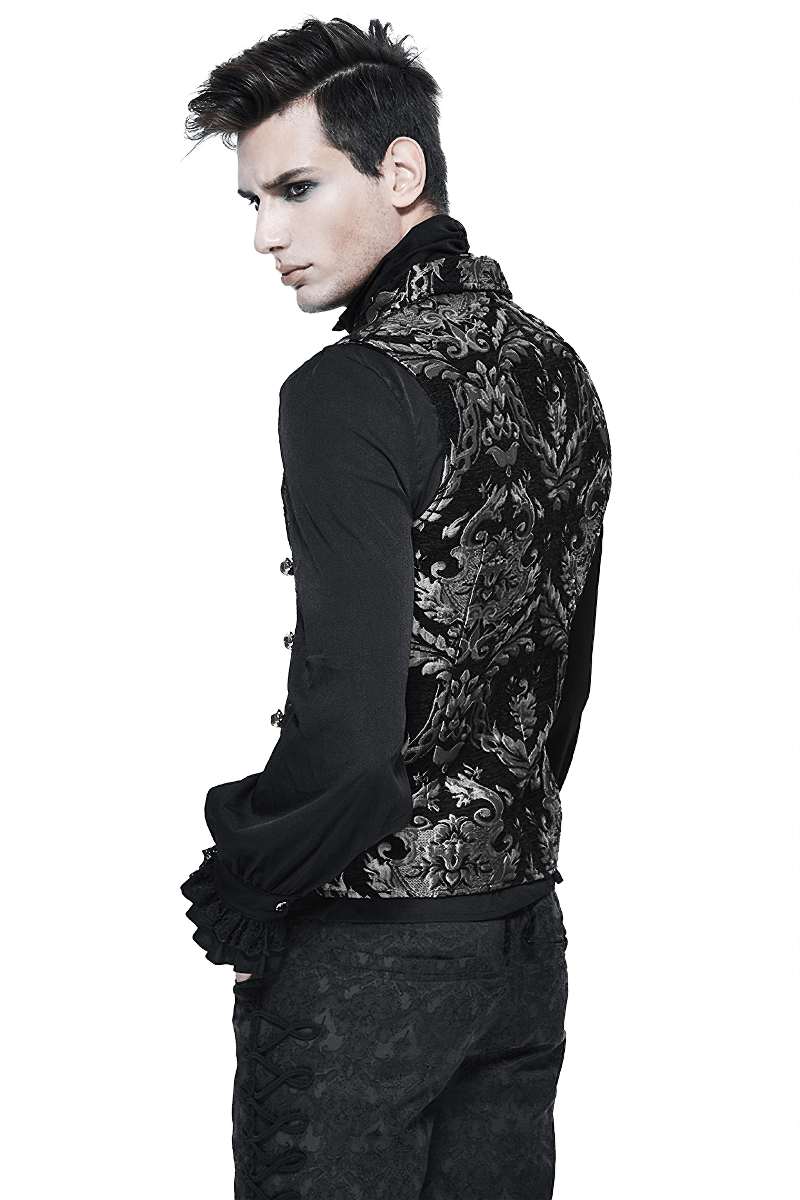 Stylish man wearing a vintage black waistcoat with silver filigree details, showcasing gothic fashion.