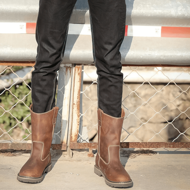 Men's vintage buckle boots with flat soles, styled with black pants, perfect for rock style fashion.