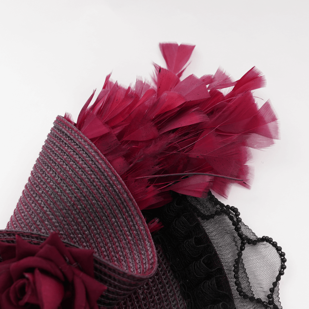 Elegant vintage burgundy and black fascinator hat featuring dramatic feathers and lace detailing.