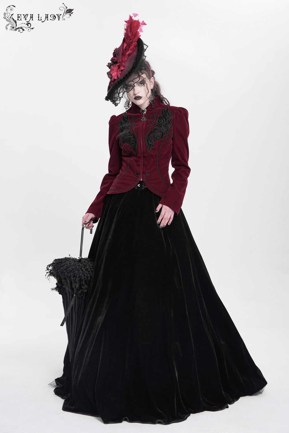 Elegant woman in gothic burgundy jacket and black skirt, wearing a dramatic fascinator hat with feathers.