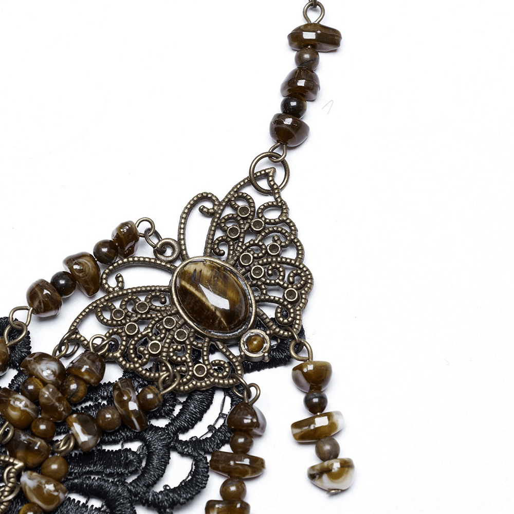 Vintage butterfly necklace with natural stones and lace detailing, showcasing elegance and strength.