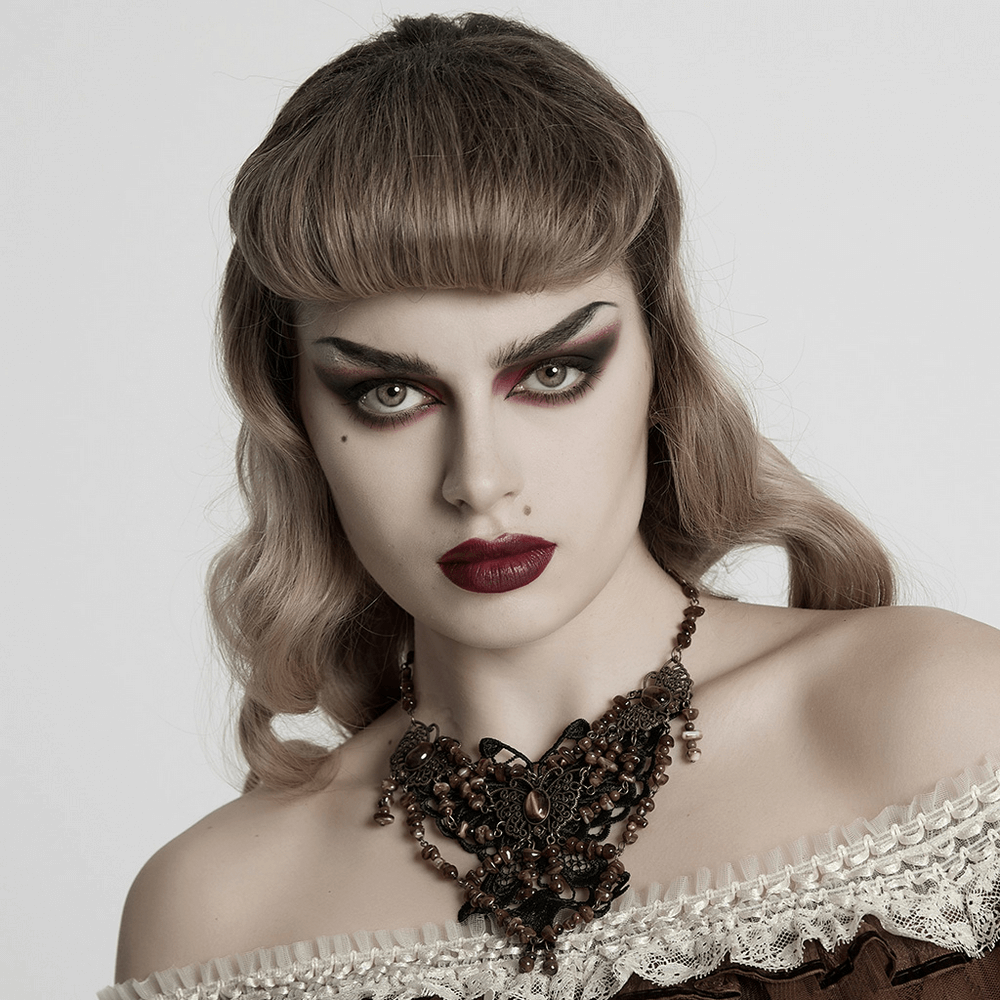 Model showcasing a vintage butterfly necklace with intricate lace and natural stones, highlighting elegance and strength.