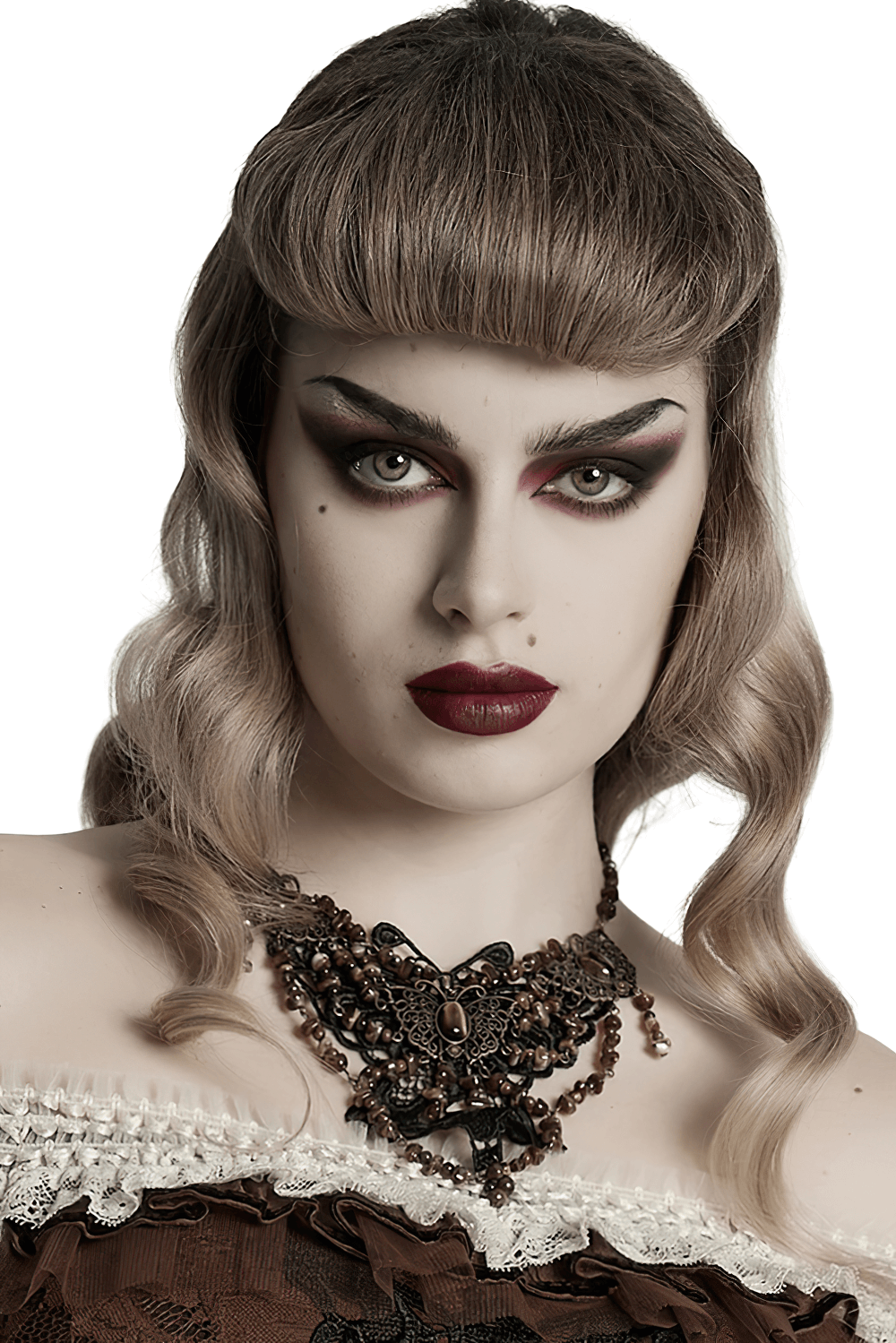 Stunning woman with vintage butterfly necklace, striking makeup, and elegant hairstyle in a stylish photo.